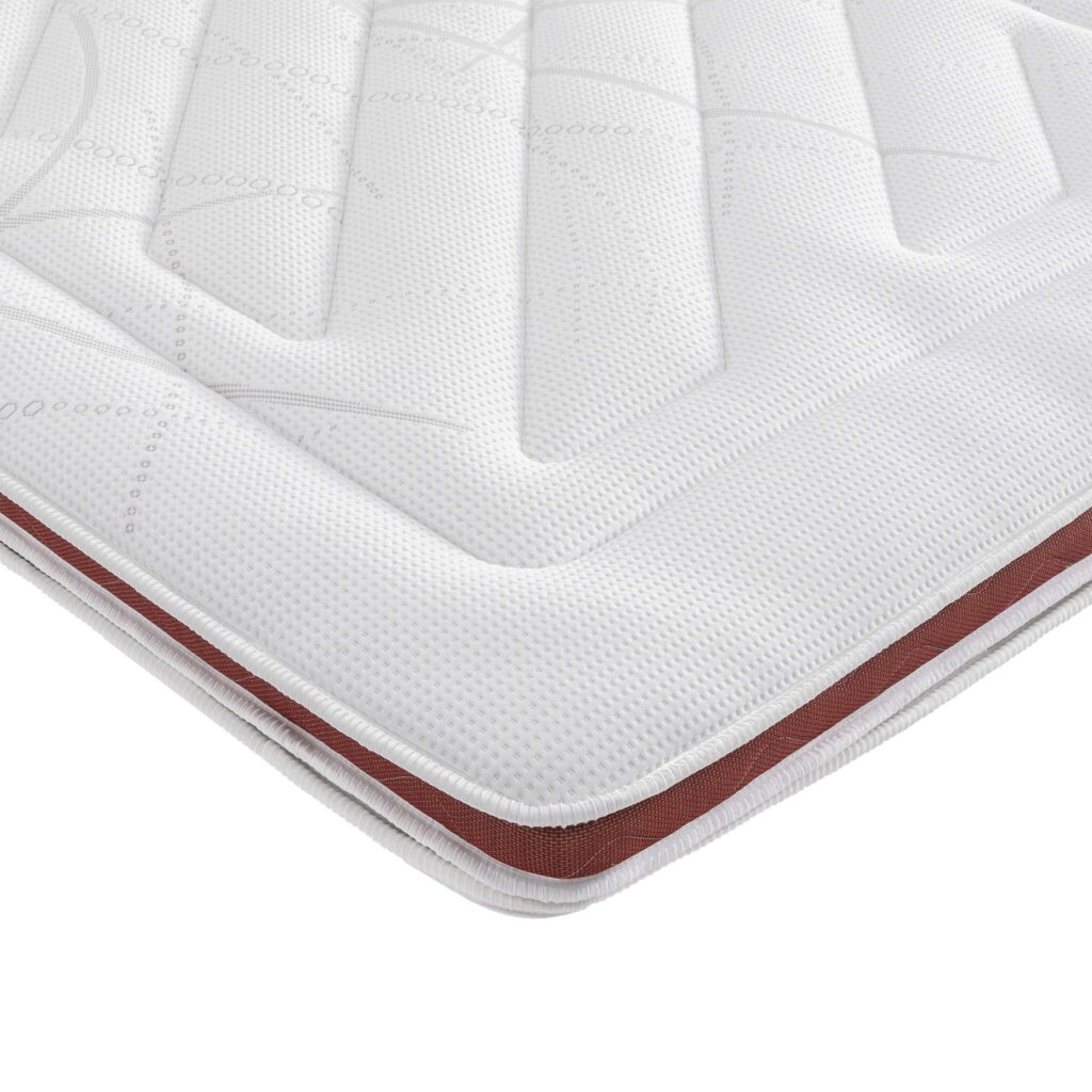 Angle du surmatelas Someo Crépuscule, housse matelassée blanche et liseré rouge